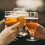 Closeup of Three Glasses of Beer Being Clinked